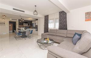 a living room with a couch and a table at Stunning Home In Sibenik - Zaboric in Zaboric