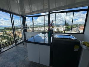 a kitchen with a counter with a view of a city at Modern apartment/Studio in Pereira +76 photos