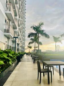 a corridor of a building with tables and chairs at Coast Residences condo near MOA, StarCity and PICC in Manila