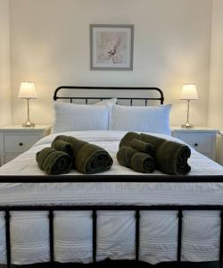 a bed with four green pillows on it at Harbourside - 2 beds, Great links to City Centre in Barry +44 photos