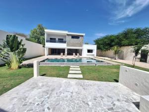 a house with a swimming pool in the yard at villa eclore 2 in Sali Tapé