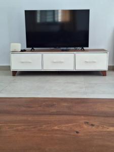 a white entertainment center with a flat screen tv on it at villa eclore 2 in Sali Tapé