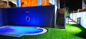 a blue wall with a swimming pool next to a house at LUXURY VILLA ZAGARA GOLF & Pool in Estepona