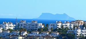a group of white apartment buildings on a hill at LUXURY VILLA ZAGARA GOLF & Pool in Estepona