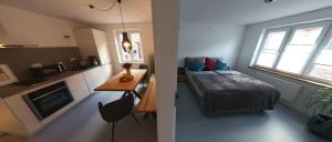 a small bedroom with a bed and a kitchen at Erftstege#2 in Bad Münstereifel