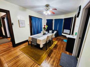 a dining room with a table and blue curtains at Home besides Niagara Falls, NY in Niagara Falls