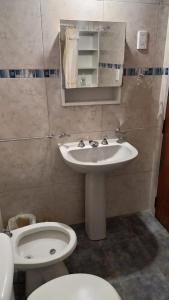 a bathroom with a sink and a toilet at Casa Icho Cruz in Villa Icho Cruz