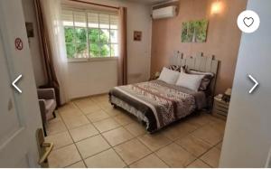 a bedroom with a bed and a window at VILLA LAURAYM in Baie-Mahault +12 photos