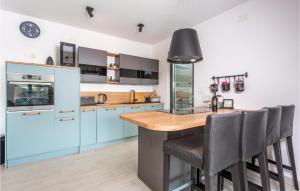 a kitchen with blue cabinets and a wooden counter top at 2 Bedroom Stunning Apartment In Omisalj in Omišalj