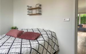 a bedroom with a bed and a shelf on the wall at Pet Friendly Home In Heinkenszand in Heinkensand