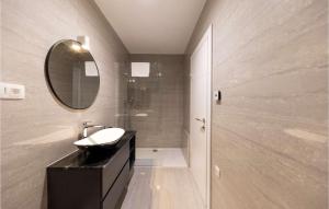a bathroom with a sink and a mirror at Villa Gina in Sukošan