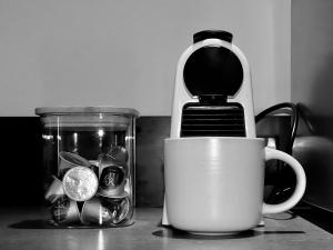a coffee cup sitting next to a jar of money at Inner City Executive Living in Hobart +48 photos