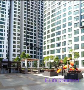 a playground in front of two tall buildings at E LIFE D Summit Residences 1315 Wifi Netflix in Johor Bahru +13 photos