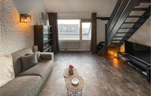 a living room with a couch and a staircase at Stunning Apartment In Bruinisse in Bruinisse