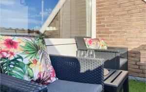two wicker chairs with colorful pillows on a patio at Stunning Apartment In Bruinisse in Bruinisse