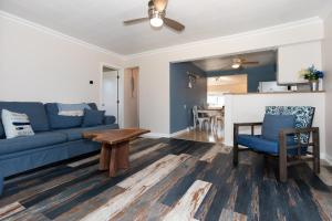 a living room with a blue couch and a table at Explorers Cottage at Rye Beach in Huron