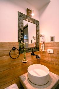 a bathroom with a sink and a mirror at Departamento Cumbe Mayo in Cajamarca +23 photos