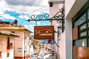 a sign for a restaurant on the side of a street at Departamento Cumbe Mayo in Cajamarca