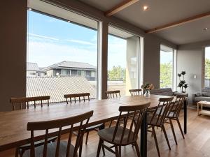 a dining room with a large table and chairs at Beach enzi ビーチ エンジ in Sanuki