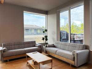 a living room with two couches and a large window at Beach enzi ビーチ エンジ in Sanuki
