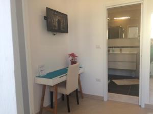 a room with a desk and a table and a mirror at Base Napoli Mergellina in Naples +103 photos