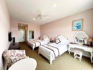 Postel nebo postele na pokoji v ubytování Ngoc Phat Dalat Hotel