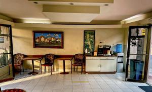 a kitchen with a table and chairs in a room at Hotel del valle in Ensenada