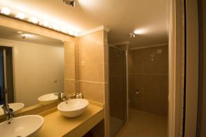 a bathroom with two sinks and a shower at Nogalera Boutique Apartment in Torremolinos