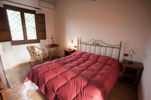 En eller flere senge i et værelse på Agriturismo Baglio Donna Santa