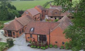 an aerial view of a large brick house at Malswick Mill in Newent