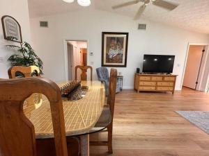 a dining room with a table and a television at Stylish budget friendly retreat! in Lake Placid