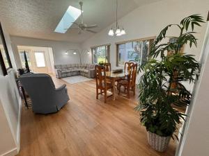 a living room with a table and a couch at Stylish budget friendly retreat! in Lake Placid