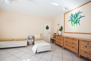 a living room with a large painting on the wall at B&B In Principio Vitae - L'infinito con tatto in Recanati