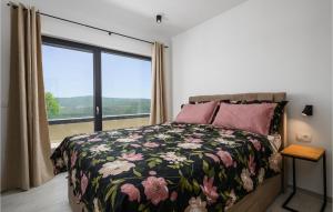 a bedroom with a bed and a large window at Villa De La Vie in Raša
