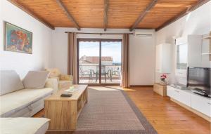 a living room with a couch and a tv at Cozy Apartment In Punat With Sauna in Punat