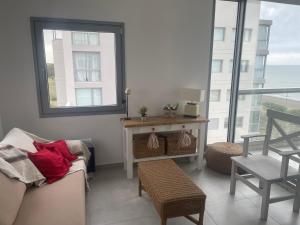 a living room with a couch and a window at Torres al mar 10 in Monte Hermoso