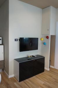 a living room with a flat screen tv on a wall at San Donato 40 in Bologna +66 photos