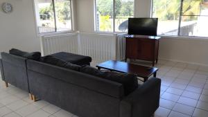 a living room with a couch and a tv at Tully Motel in Tully