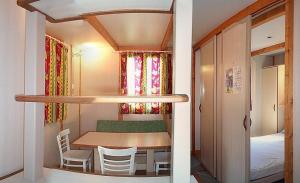 a small room with a table and chairs and a bed at Camping Bungalows Mariola in Bocairent +26 photos