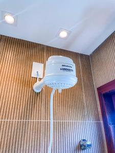 a hair dryer on the wall of a bathroom at Pousada Solarium in Canoa Quebrada +72 photos
