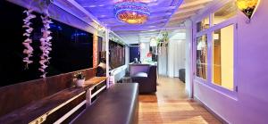 a bar with purple walls and a purple ceiling at Gustav Bali Homestay and Massage in Sanur