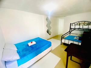 a bedroom with two bunk beds and a piano at Hibiscus Dive Inn in Pooc
