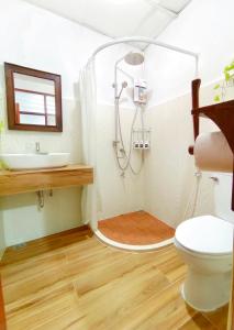 a bathroom with a shower and a toilet and a sink at Aphilapa House in Chiang Mai +44 photos