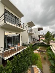 a house with a river in front of it at The Episode Boutique Hotel in Suratthani