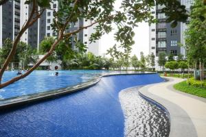 a swimming pool in a city with tall buildings at Bayview Bliss in Pulau Kempas