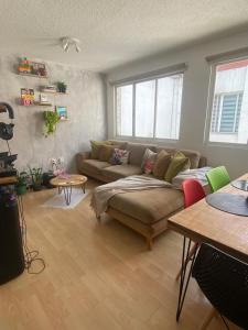 a living room with a couch and a table at Habitación Privada en La Colonia Roma in Mexico City