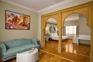 a living room with a couch and a bedroom at Storii By ITC Hotels, Jaisalmer in Jaisalmer