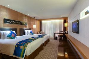 Voodi või voodid majutusasutuse Shenzhen Dameisha Kingkey Palace Hotel toas
