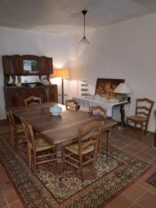 a dining room with a wooden table and chairs at El Paller Mas Vidalou in Céret