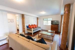 a living room with a couch and a tv at Tree & Sea sleeps 11 in Point Lookout